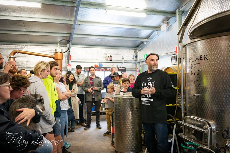 Picture of people viewing the Capertee Craft Works Distillery. Other items in Background.